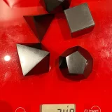 5 Shungite Plutonic Solids on a scale