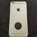 Shungite Flower of Life EMF Protector disc on back of a phone