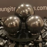 Shungite Spheres 3 of sitting on a polished Shungite Tile