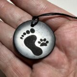 Shungite pendant with foot print and paw print